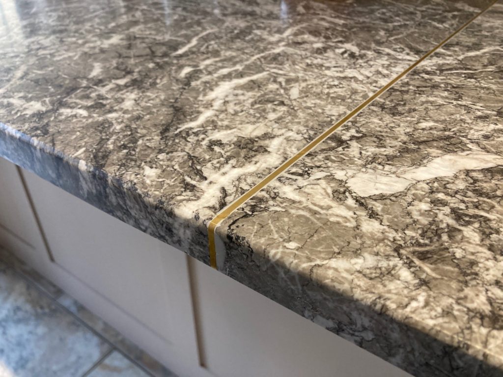 Brass inlay with reclaimed marble kitchen worktop